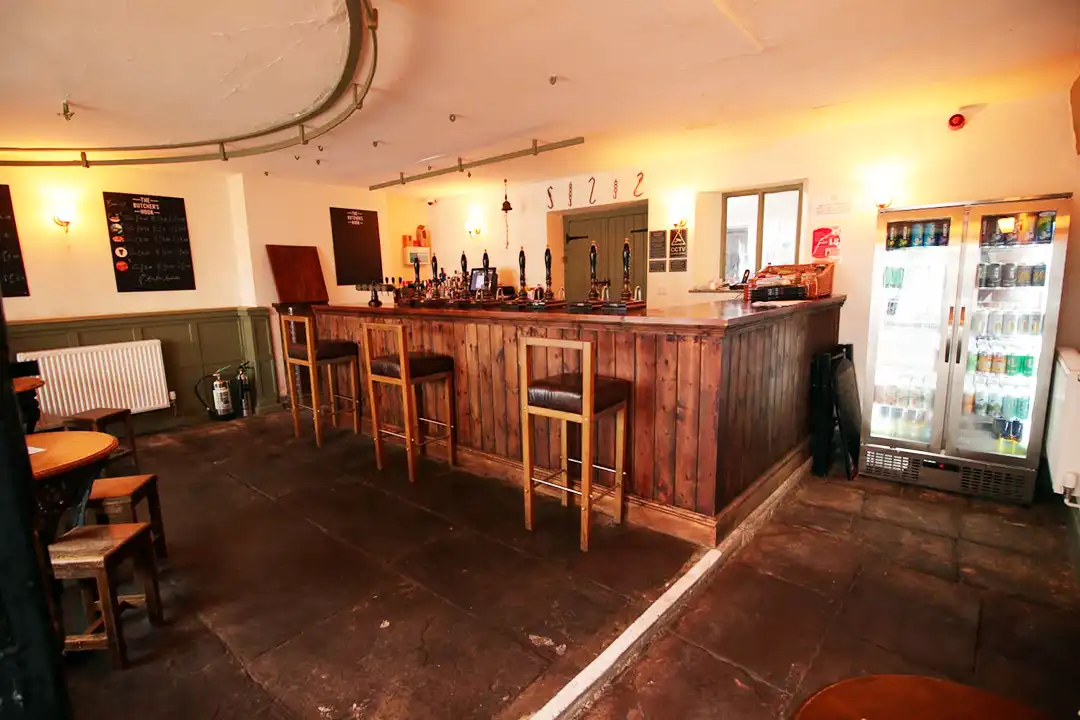 The warm wooden bar and stools inside The Butcher’s Hook in Thornbury.