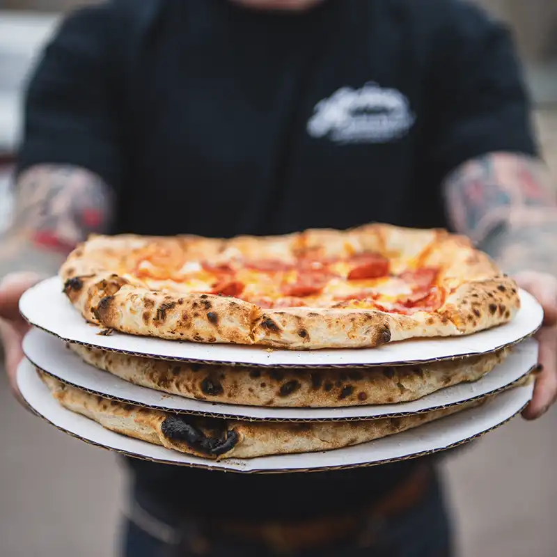 Pizzas being served